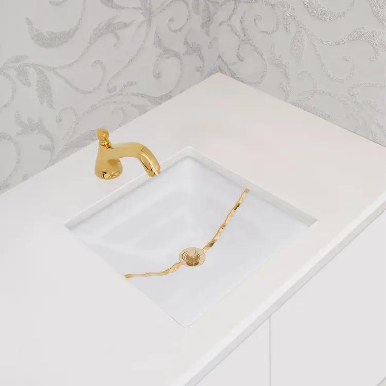 white glass with gold accent sink