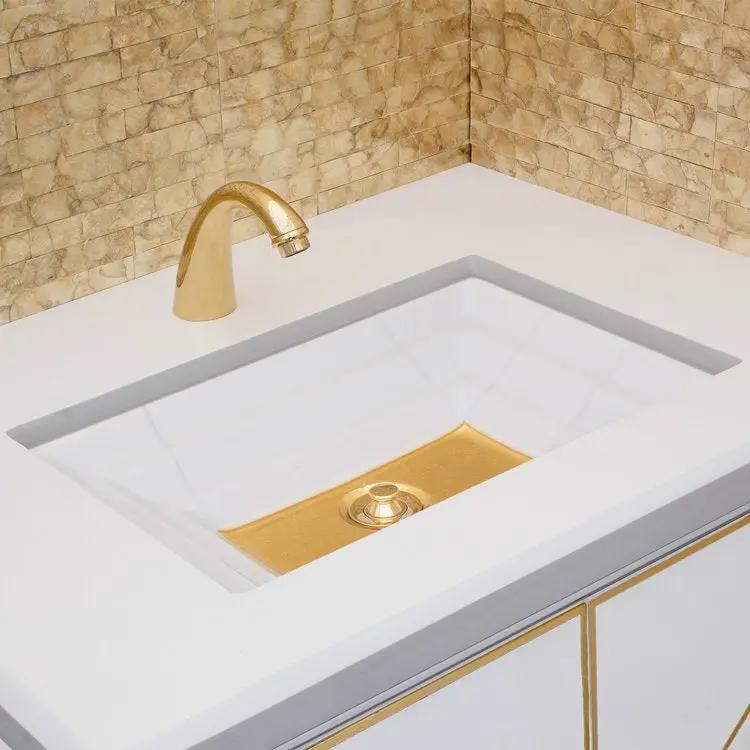 white glass with gold accent sink